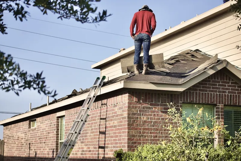 Professional roofer working on a residential roof in Cedarburg